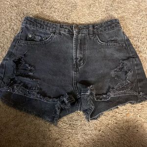 They are black ripped jean shorts. Most comfortable jeans shorts I’ve ever worn.